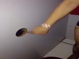Wife sucks cocks at the gloryhole then produces a group of men cum in theatre